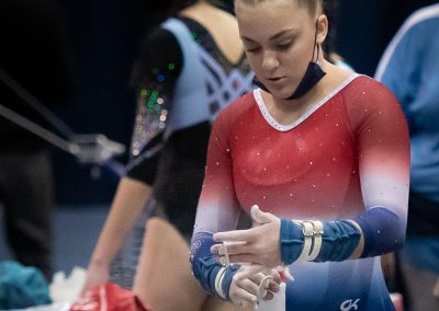 Team gymnast adjusting grip