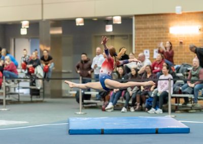 Team gymnast doing a right-leg leap