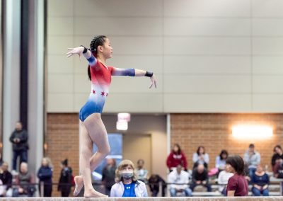 Team gymnast posing on the balance beam