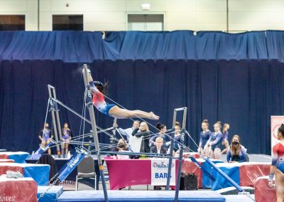 Team gymnast swinging on the bar